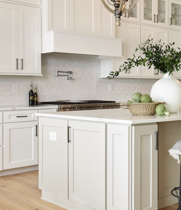 luxury vinyl in kitchen with blue island and marble backsplash